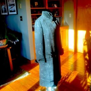 Sculpted coat of black brocade and faux fur mandarin collar.